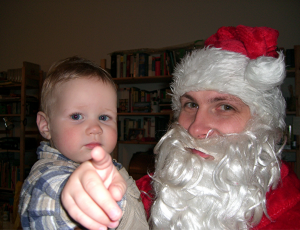 Der Weihnachtsmann mit einem sehr jungen Fan auf dem Arm